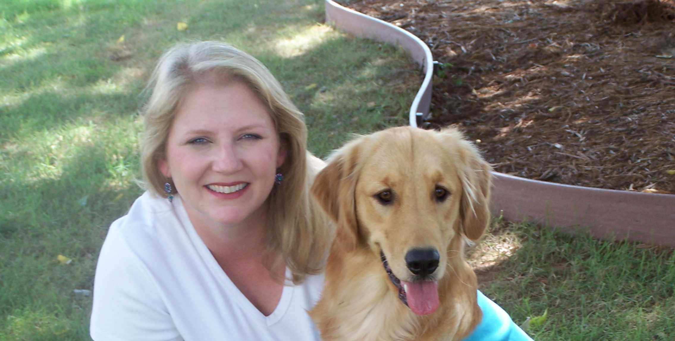 An assistant instructor with a Golden Retriever at a training session